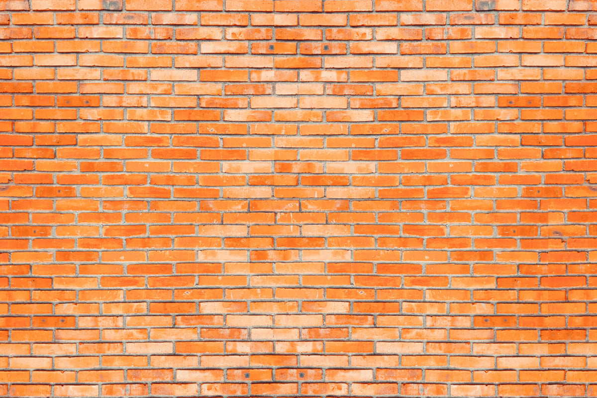 Tapete in Backsteinoptik – leuchtend orangefarbene Backsteinwand